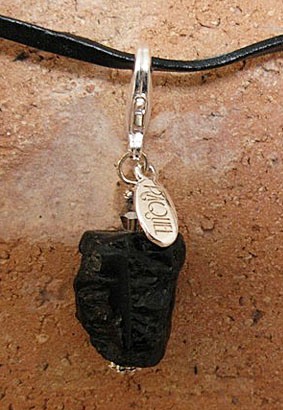 images/black tourmaline pawmulet on brick